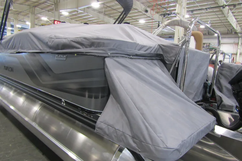 Slide: The Image of 2026 Avalon Venture 85 Center Console Fish boat covered in a protective tarp indoors. - 18