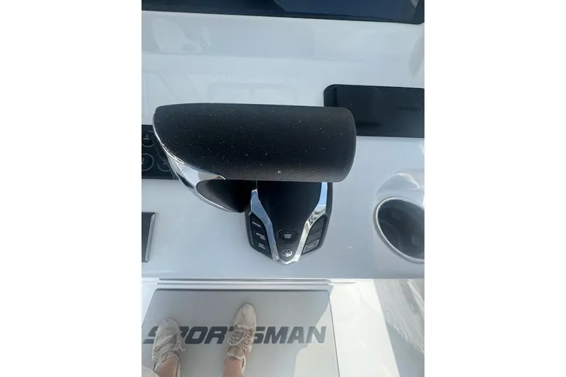 Slide: The Image of 2025 Sportsman Open 232 Center Console throttle control on boat dashboard. - 10