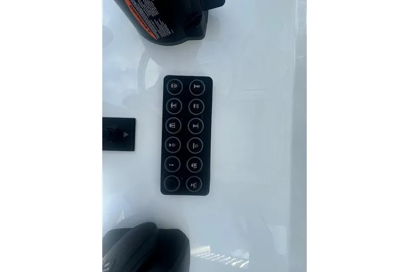 Slide: The Image of Control panel of 2025 Sportsman Open 232 Center Console boat, featuring multiple buttons. - 11