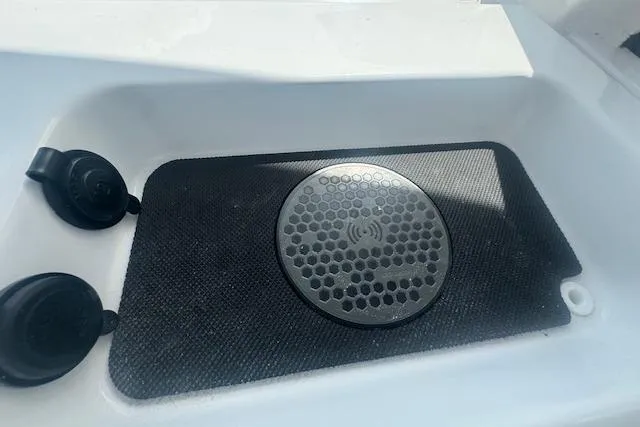 Slide: The Image of 2025 Sportsman Open 232 Center Console boat speaker and charging pad detail. - 13