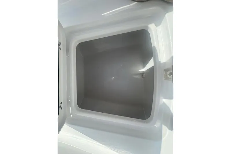 Slide: The Image of Open storage compartment of 2025 Sportsman Open 232 Center Console boat. - 18