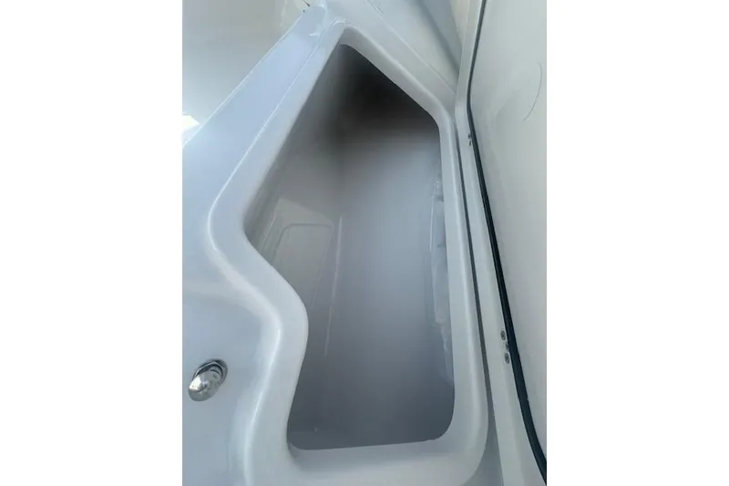 Slide: The Image of 2025 Sportsman Open 232 Center Console storage compartment interior view. - 19