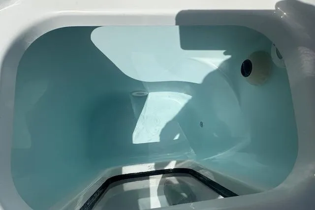 Slide: The Image of 2025 Sportsman Open 232 Center Console livewell interior with water, showcasing design and functionality. - 8