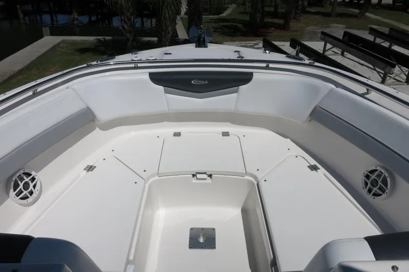 Slide: The Image of 2021 Robalo R247 Dual Console boat interior with spacious seating and storage compartments. - 11