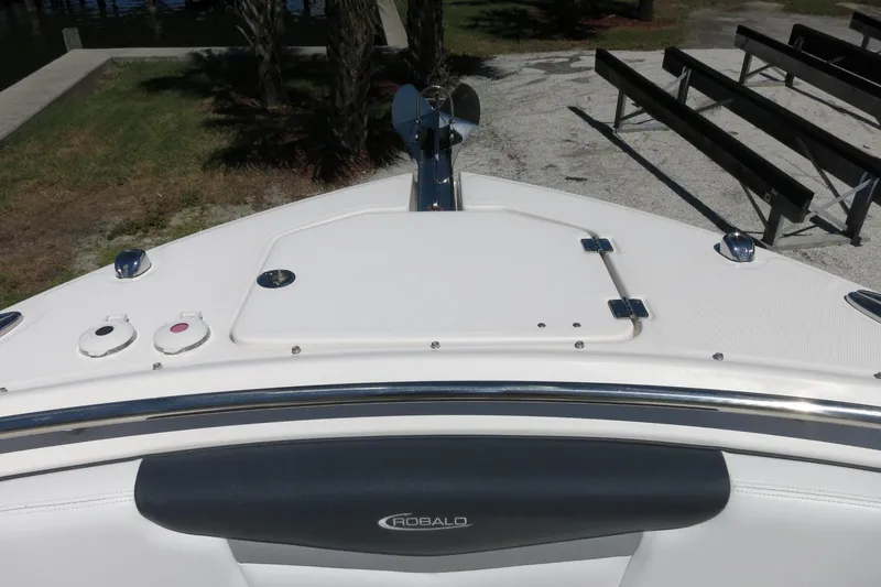 Slide: The Image of 2021 Robalo R247 Dual Console boat bow with anchor and seating area. - 12