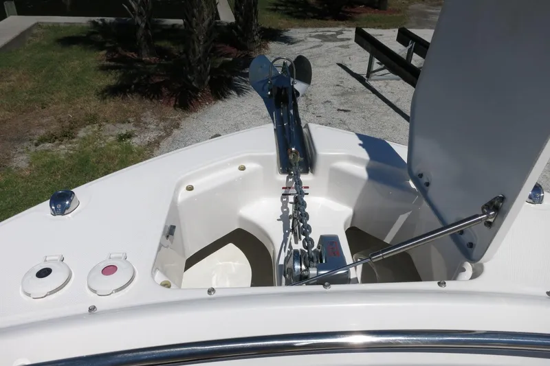 Slide: The Image of 2021 Robalo R247 Dual Console boat anchor compartment with chain and winch. - 13