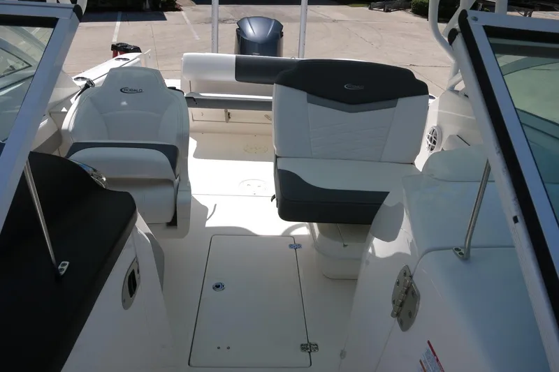 Slide: The Image of 2021 Robalo R247 Dual Console boat interior with seating and storage compartments. - 16