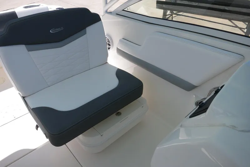 Slide: The Image of 2021 Robalo R247 Dual Console boat interior with cushioned seating. - 18