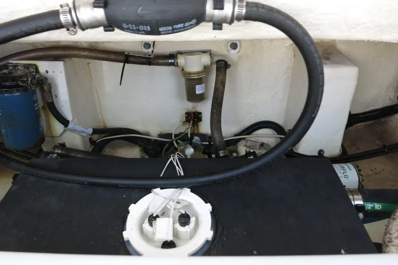 Slide: The Image of 2021 Robalo R247 Dual Console engine compartment with hoses and components. - 25