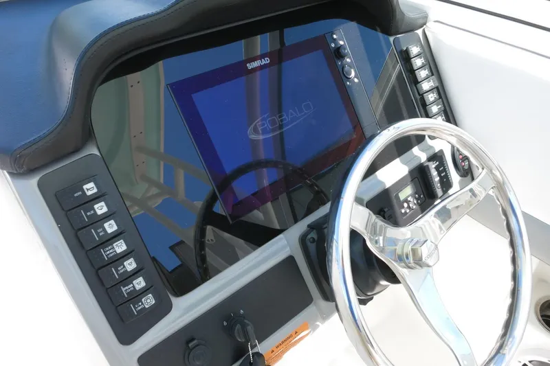 Slide: The Image of 2021 Robalo R247 Dual Console dashboard with steering wheel and control panel. - 29