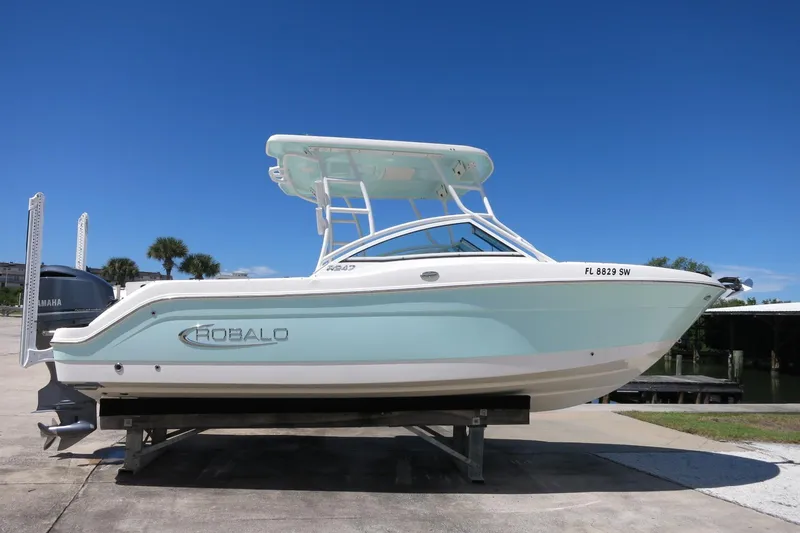 Slide: The Image of 2021 Robalo R247 Dual Console boat on display under clear blue sky. - 3