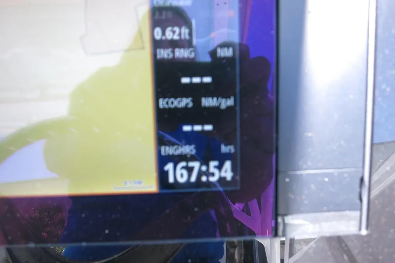 Slide: The Image of Display screen of 2021 Robalo R247 Dual Console showing engine hours at 167:54. - 31
