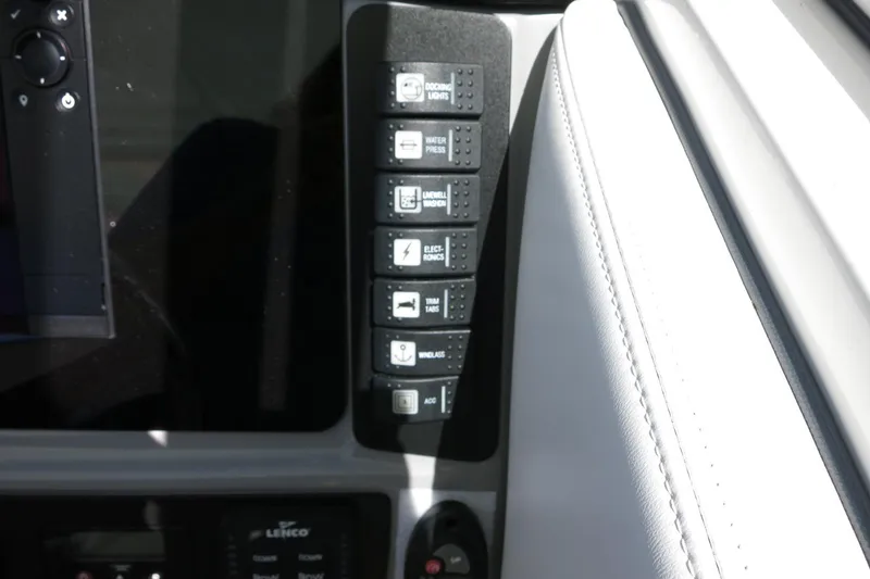 Slide: The Image of 2021 Robalo R247 Dual Console dashboard with control panel and switches. - 33