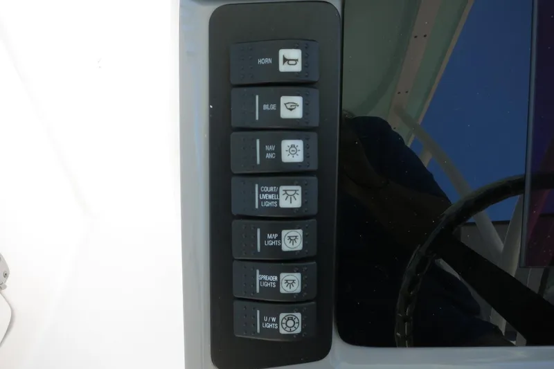 Slide: The Image of Control panel of 2021 Robalo R247 Dual Console boat with labeled switches. - 34