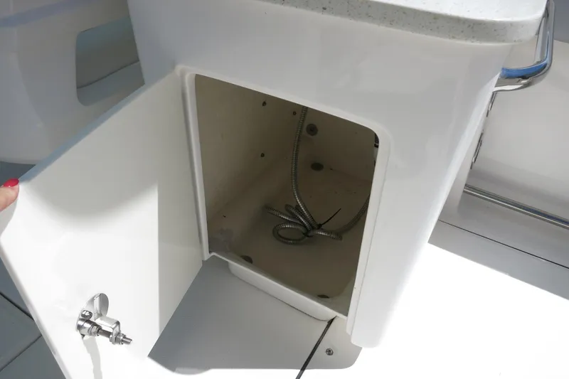 Slide: The Image of Open storage compartment on 2021 Robalo R247 Dual Console boat. - 39