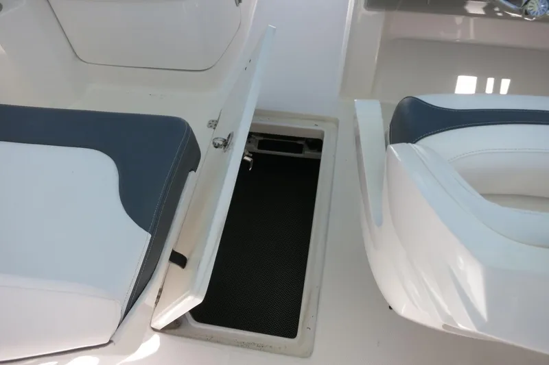 Slide: The Image of 2021 Robalo R247 Dual Console boat interior with open storage compartment. - 40