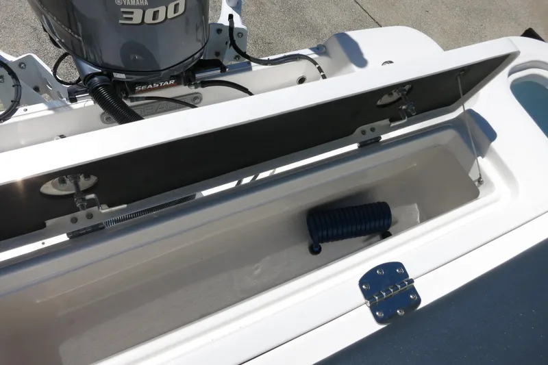 Slide: The Image of 2021 Robalo R247 Dual Console boat with Yamaha 300 engine and storage compartment. - 45