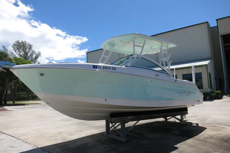Slide: The Image of 2021 Robalo R247 Dual Console boat on display outdoors, clear sky background. - 5