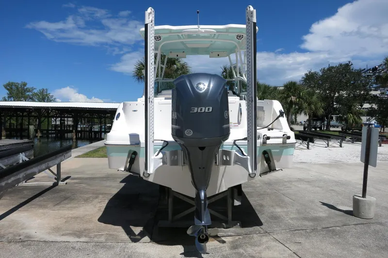 Slide: The Image of 2021 Robalo R247 Dual Console boat with Yamaha 300 engine, docked outdoors. - 7
