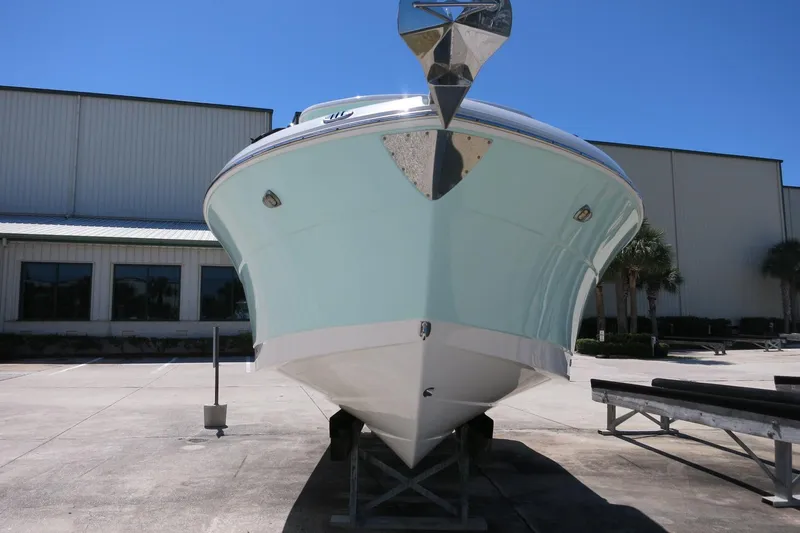 Slide: The Image of 2021 Robalo R247 Dual Console boat on display outside a warehouse. - 8