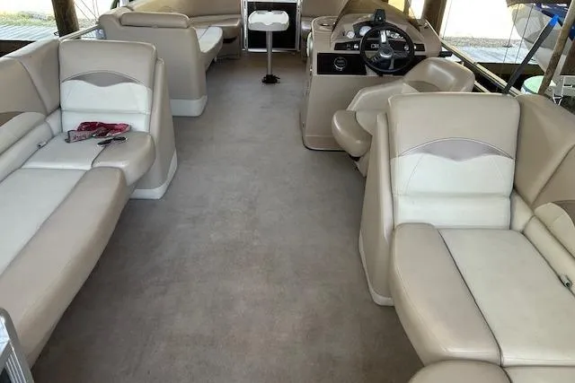 Slide: The Image of 2016 Harris Cruiser 240 interior with beige seating and steering console. - 6