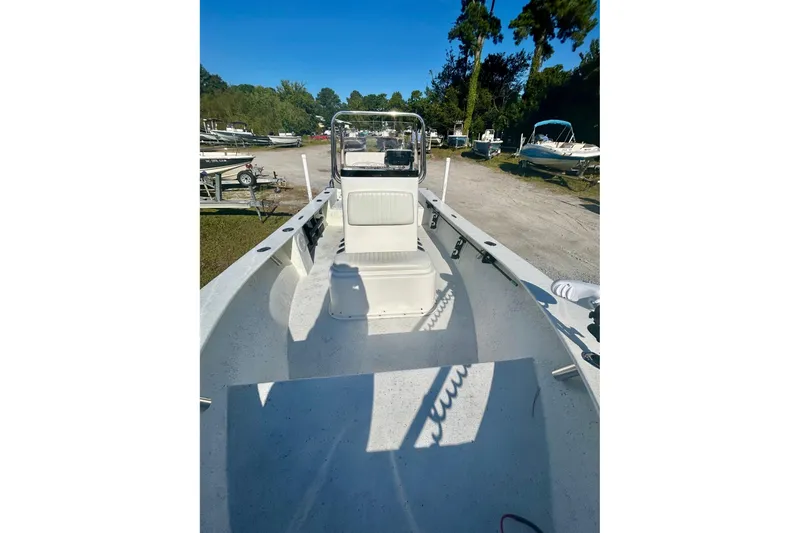 Slide: The Image of 2017 May-Craft 1800CC boat interior with seating and console, parked outdoors. - 4