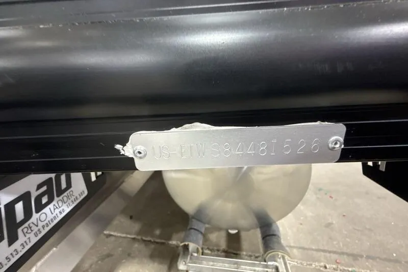 Slide: The Image of 2026 Bennington 26 MFBSF pontoon boat with tan seating in showroom. - 10