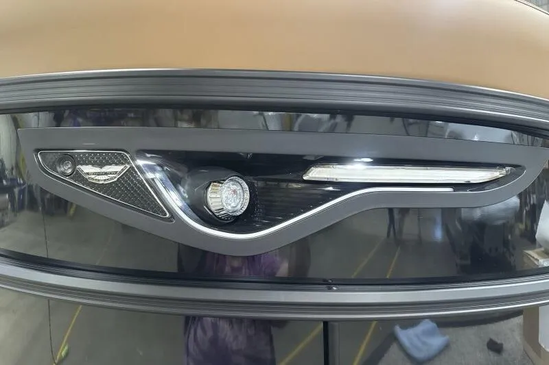 Slide: The Image of 2026 Bennington 26 MFBSF boat interior with tan seating and pink LED lighting. - 13