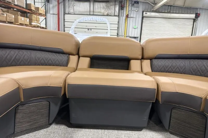 Slide: The Image of 2026 Bennington 26 MFBSF boat interior with tan seating and green LED lighting. - 16