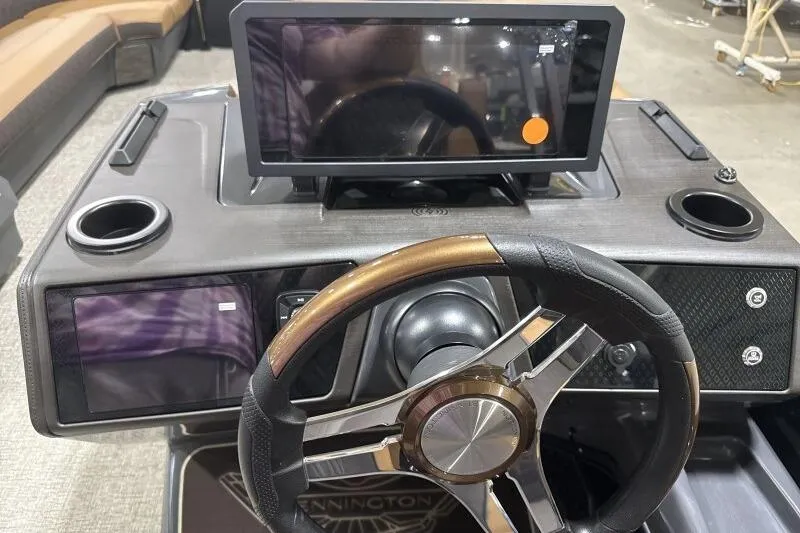 Slide: The Image of 2026 Bennington 26 MFBSF pontoon boat interior with tan seating and pink LED lighting. - 20