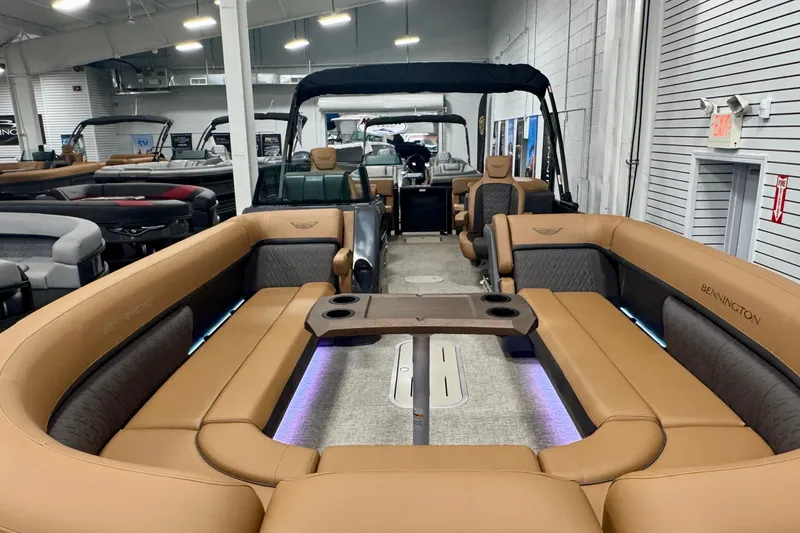 Slide: The Image of 2026 Bennington 26 MFBSF pontoon boat interior with tan seating and modern design. - 32