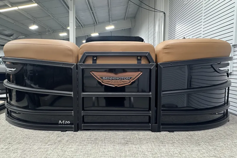 Slide: The Image of 2026 Bennington 26 MFBSF pontoon boat with tan seating and sleek black exterior. - 33
