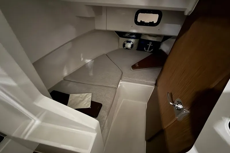 Slide: The Image of 2024 Jeanneau NC Sport 795 Series 2 cabin interior with cozy bedding and nautical decor. - 18
