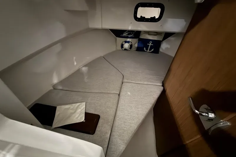 Slide: The Image of 2024 Jeanneau NC Sport 795 Series 2 cabin interior with nautical-themed cushions. - 19