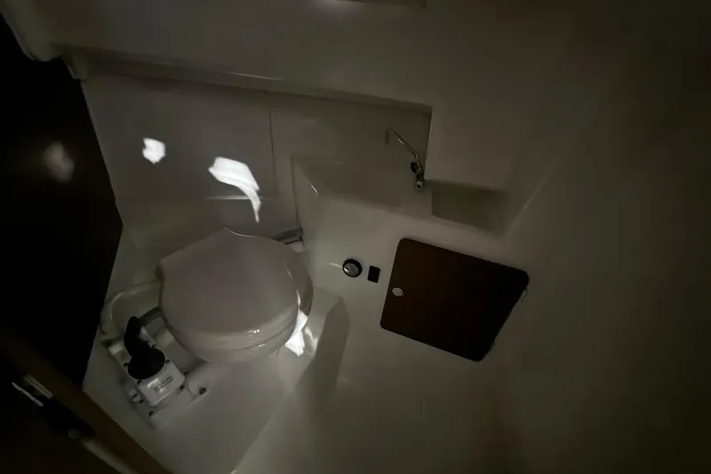 Slide: The Image of 2024 Jeanneau NC Sport 795 Series 2 boat bathroom interior with toilet and sink. - 20