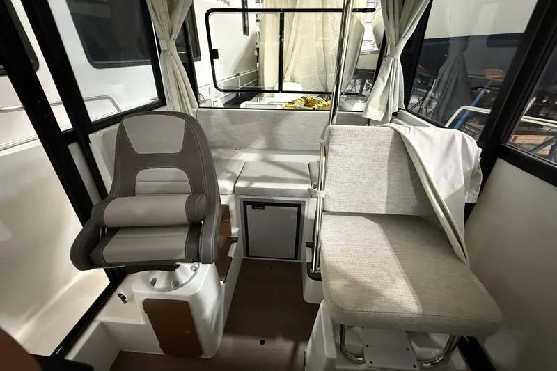 Slide: The Image of 2024 Jeanneau NC Sport 795 Series 2 interior with seating and helm station. - 21