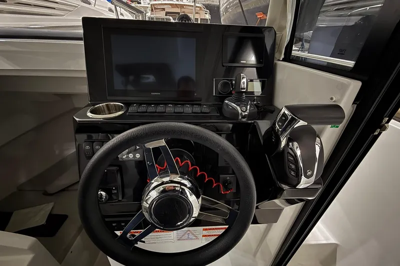 Slide: The Image of 2024 Jeanneau NC Sport 795 Series 2 helm with modern controls and navigation display. - 23