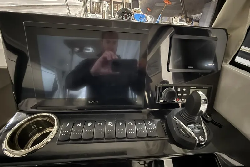 Slide: The Image of 2024 Jeanneau NC Sport 795 Series 2 dashboard with Garmin display and controls. - 25