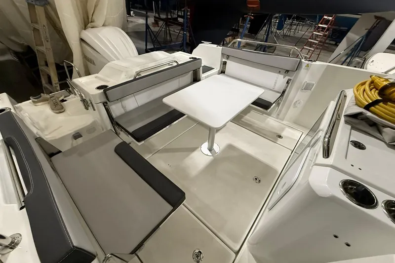 Slide: The Image of 2024 Jeanneau NC Sport 795 Series 2 boat interior with seating and table setup. - 7