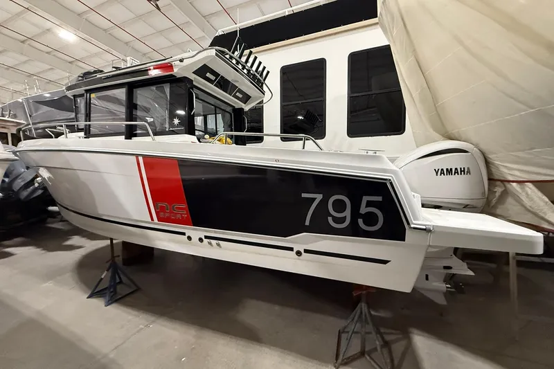 The Image of 2024 Jeanneau NC Sport 795 Series 2 boat in showroom, side view with Yamaha engine. - 1