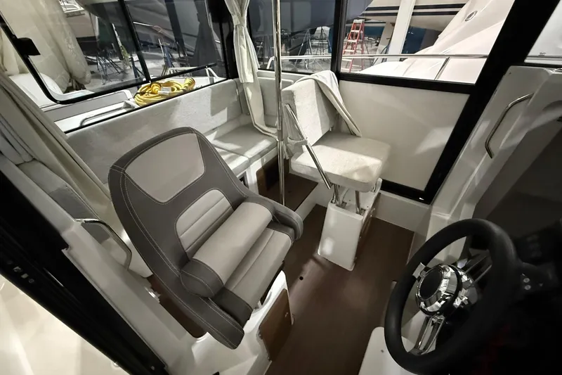 Slide: The Image of Interior of 2024 Jeanneau NC Sport 795 Series 2 boat, featuring seating and steering wheel. - 17