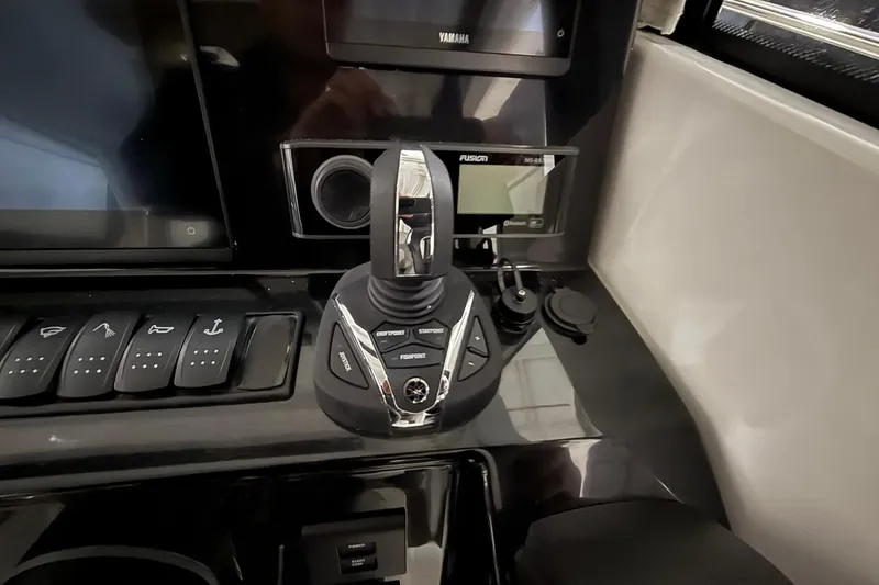 Slide: The Image of 2024 Jeanneau NC Sport 795 Series 2 dashboard with control panel and joystick. - 24