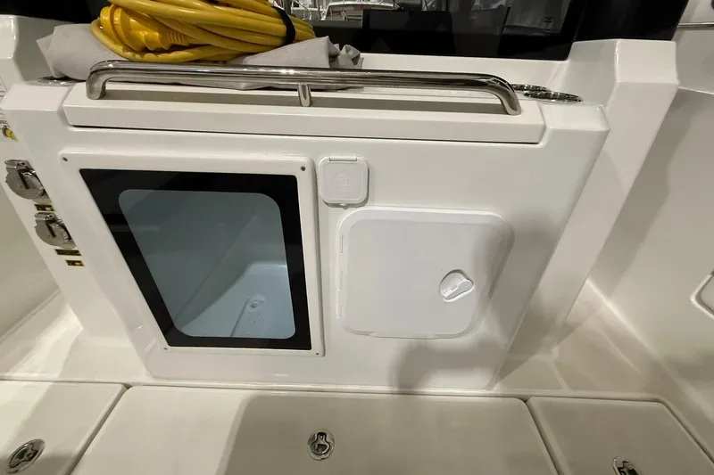 Slide: The Image of 2024 Jeanneau NC Sport 795 Series 2 boat interior with storage compartments and yellow cable. - 8