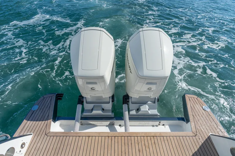Slide: The Image of Twin outboard motors on 2025 MJM 42 yacht, cruising through ocean waters. - 11