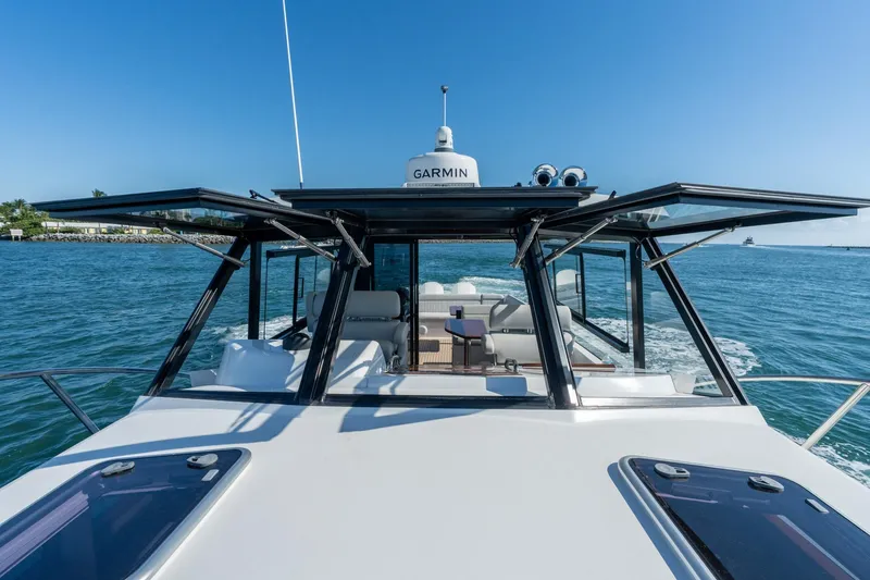 Slide: The Image of 2025 MJM 42 yacht cruising on open water with open windows and Garmin equipment. - 17