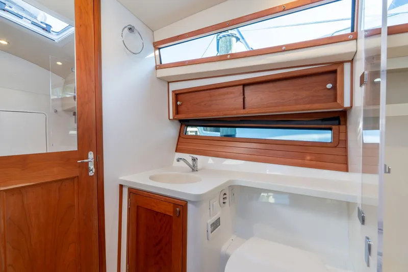 Slide: The Image of Luxurious 2025 MJM 42 yacht bathroom with wooden cabinetry and modern fixtures. - 29