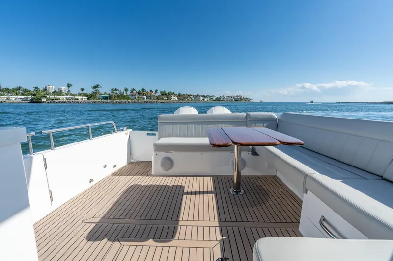 Slide: The Image of Luxurious 2025 MJM 42 yacht deck with seating and table, overlooking serene ocean view. - 31