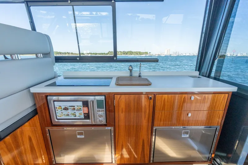 Slide: The Image of Modern kitchen on 2025 MJM 42 yacht with ocean view, featuring sleek wood cabinetry and appliances. - 33