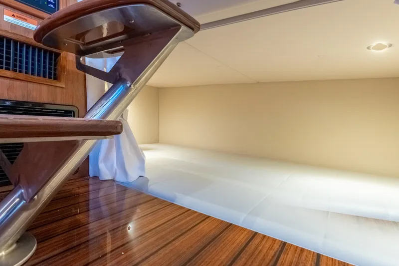 Slide: The Image of Interior of 2025 MJM 42 yacht, featuring wooden steps and a cozy sleeping area. - 35