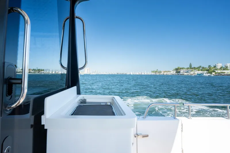 Slide: The Image of 2025 MJM 42 yacht cruising on a sunny day with coastal view. - 37